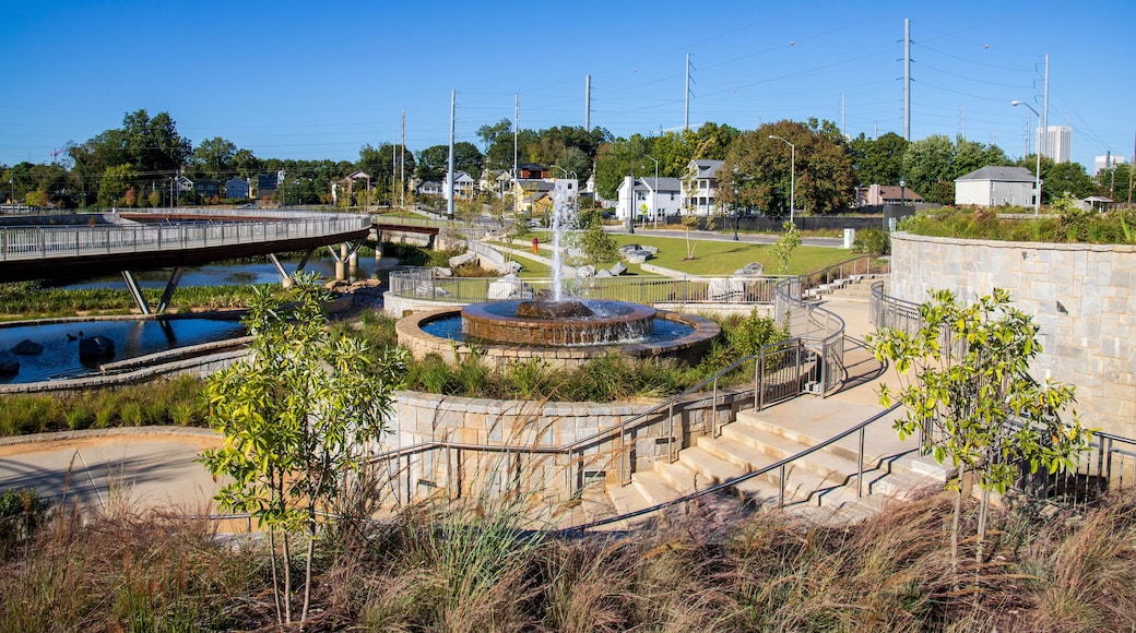 a gorgeous autumn landscape at Rodney Cook Sr. Park in Historic Vine City with water fountains surrounded by lush green trees, grass and plants with a gorgeous blue sky in Atlanta Georgia USA