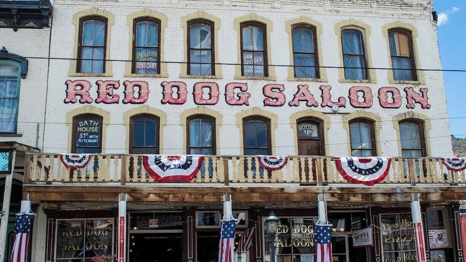 A building with a sign reading "Red Dog Saloon" and "Bath House."