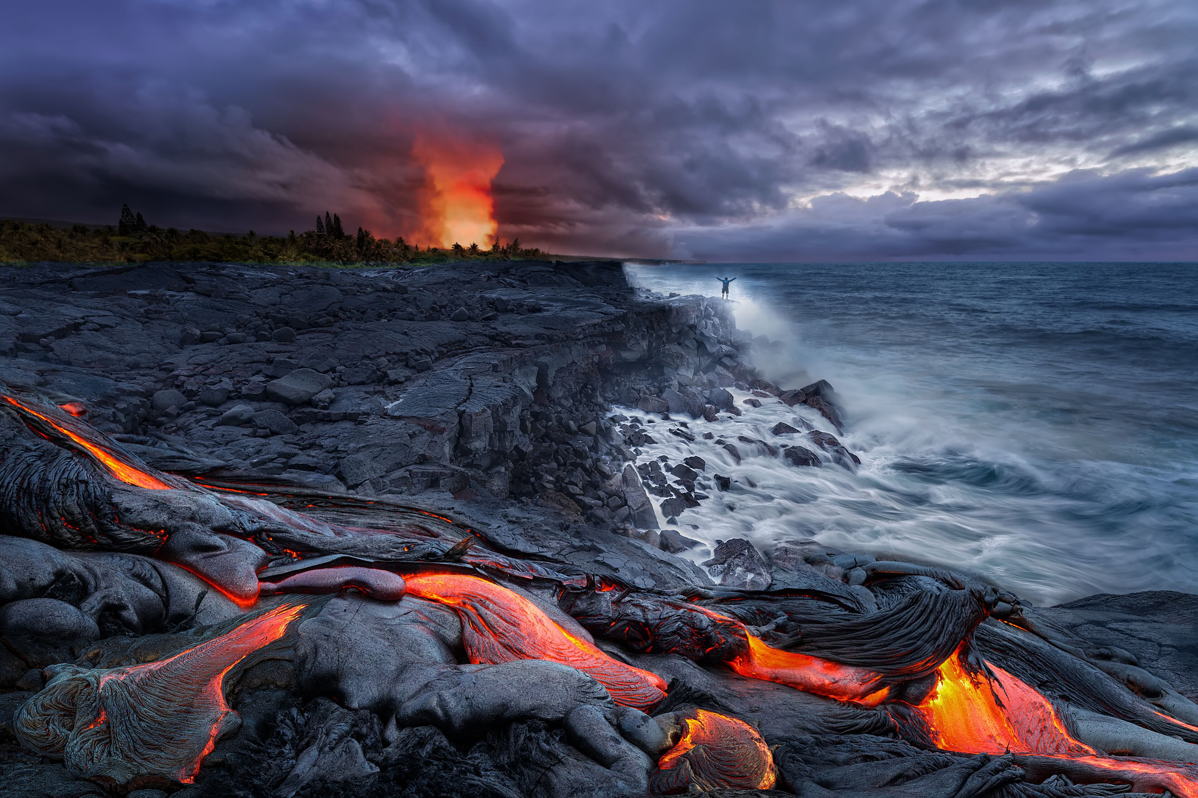 A lava flow, ocean waves, and a stormy sky.