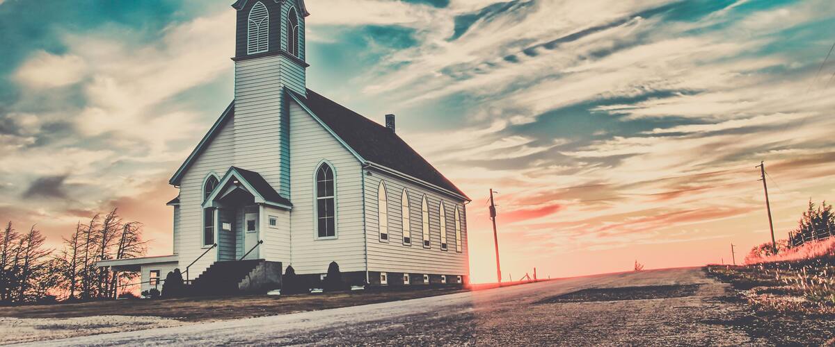 Ellis County, KS, USA - A Lone Wooden Christian Church at Dusk Sunset Skies in the Western Kansas Prairie