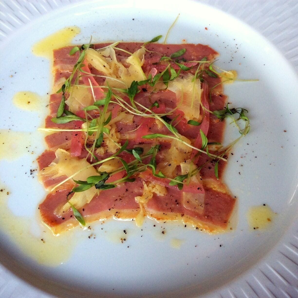 Duck prosciutto with arugula, amazu butter, pickled red onions. 
