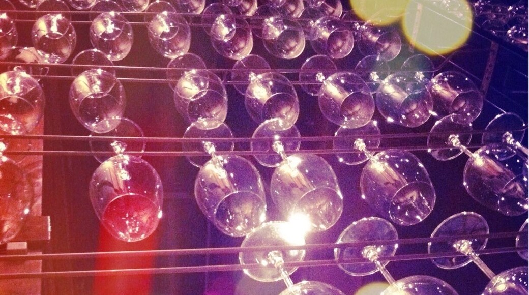 Brilliant idea of using wine glass racks as a wall divider! Nice restaurant design.