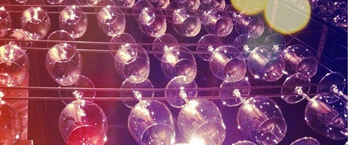 Brilliant idea of using wine glass racks as a wall divider! Nice restaurant design.