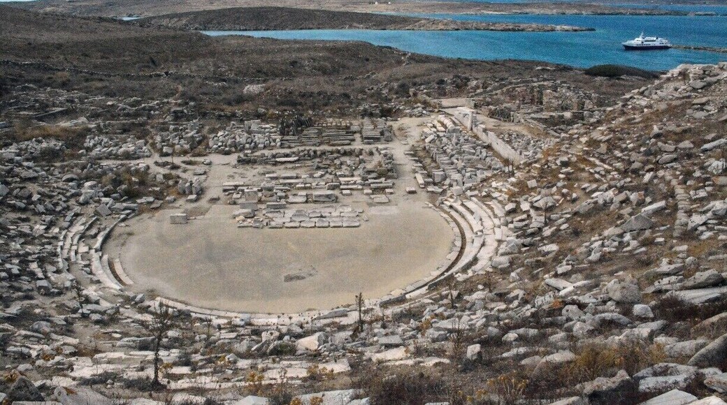 Delos was once the commercial and sacred heart of the Cyclades, with tens of thousands of people. Now it is an unpopulated ruin and a UNESCO World Heritage Site. It's a quick ferry ride from Mykonos. Here is its theatre from its summit. http://timeanddestination.com/exploring-ruins-delos-greece/