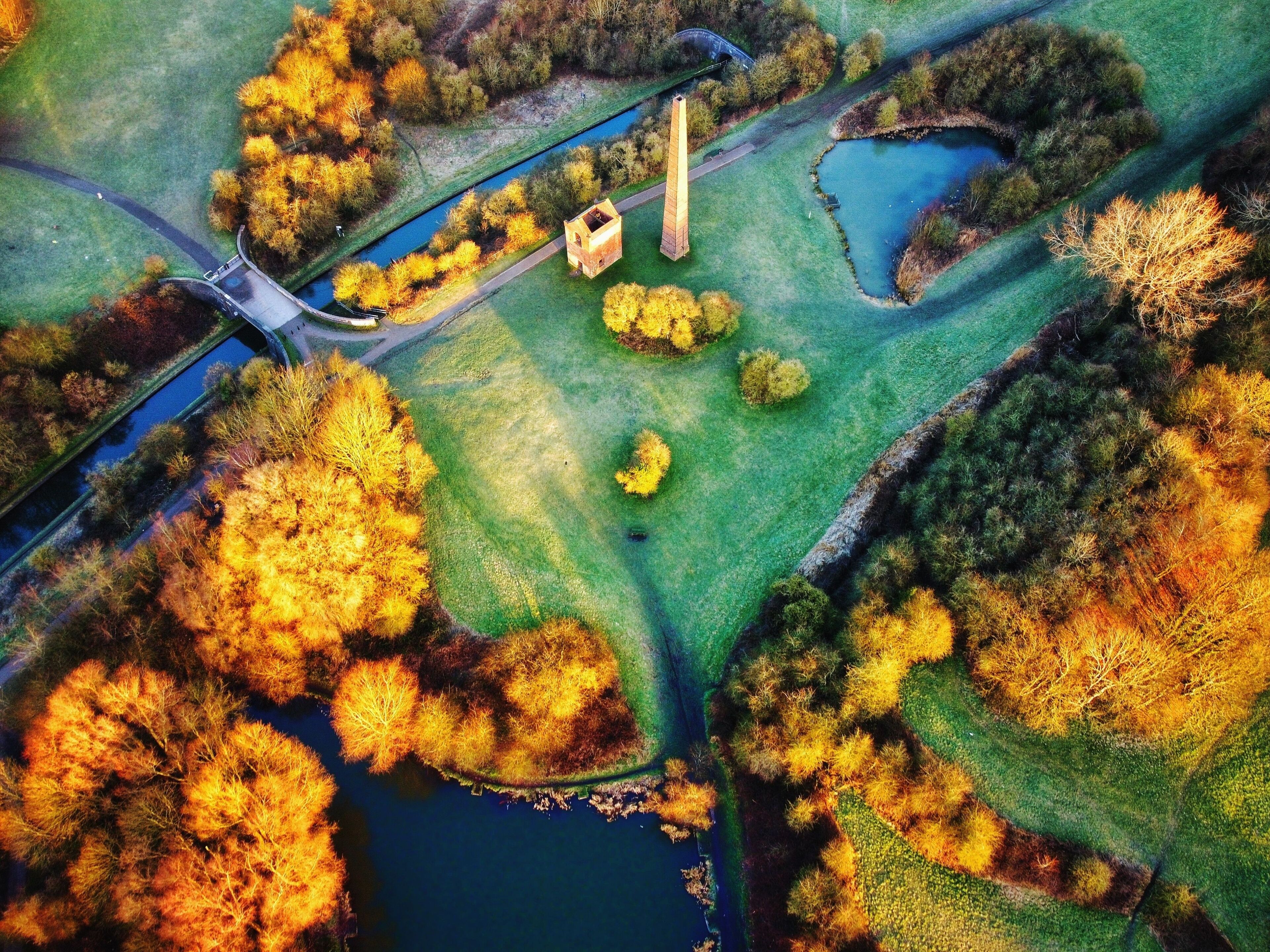 The Cobbs Engine House surrounded by colorful plants and trees in Warren's Hill Nature Reserve