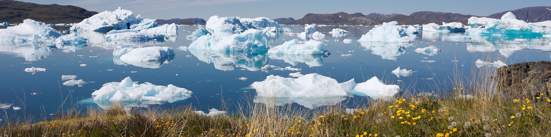 Beautiful view of icebergs floating by Narsaq city in South Greenland