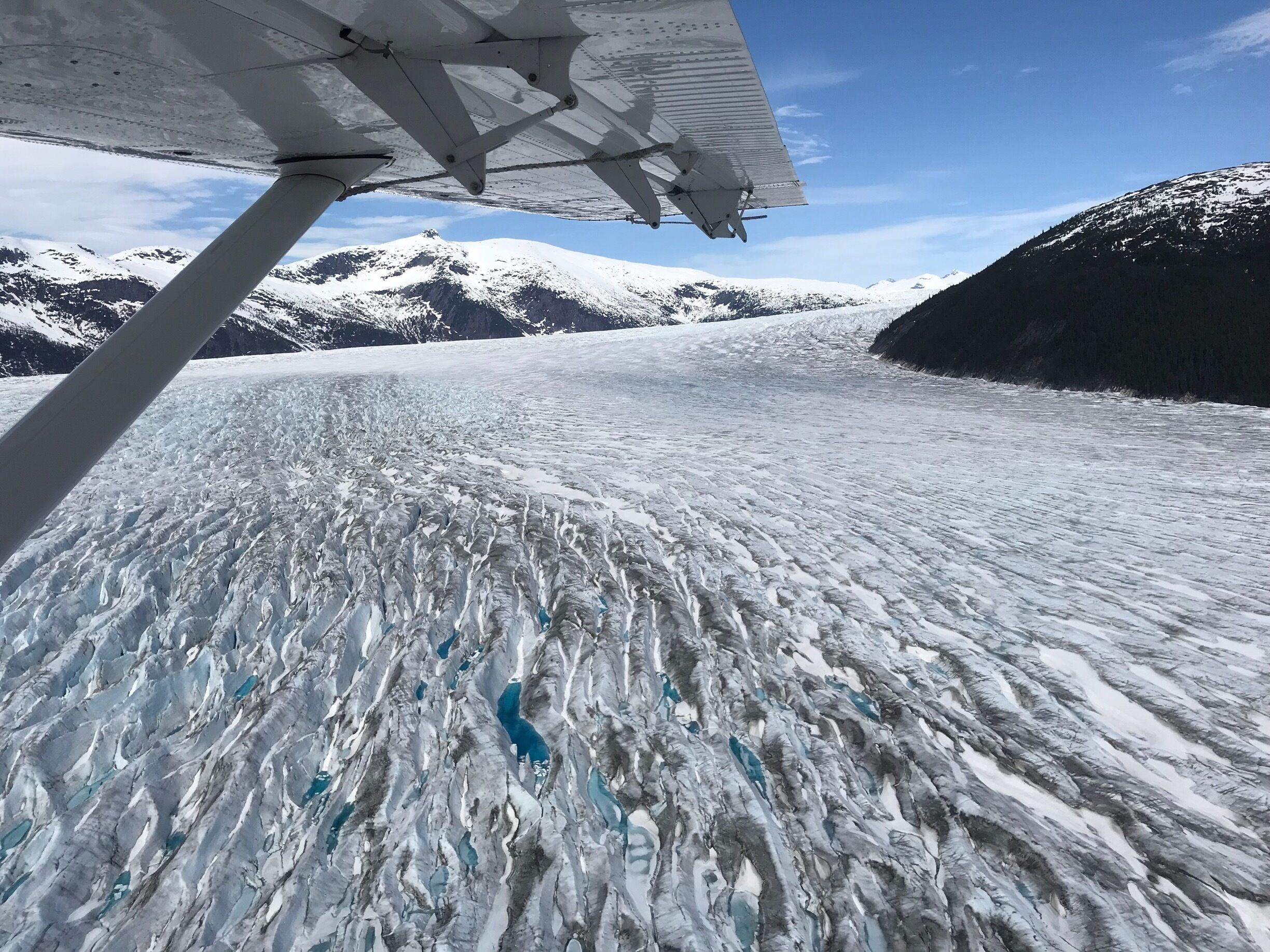 A de Havilland Otter is the quintessential Alaskan bush plane to fly you high above the deepest subalpine glacier on the planet, where you soar across an endless sea of ice dotted with aquamarine  moulins. The floatplanes depart regularly from the waterfront of downtown Juneau #BVSBlue