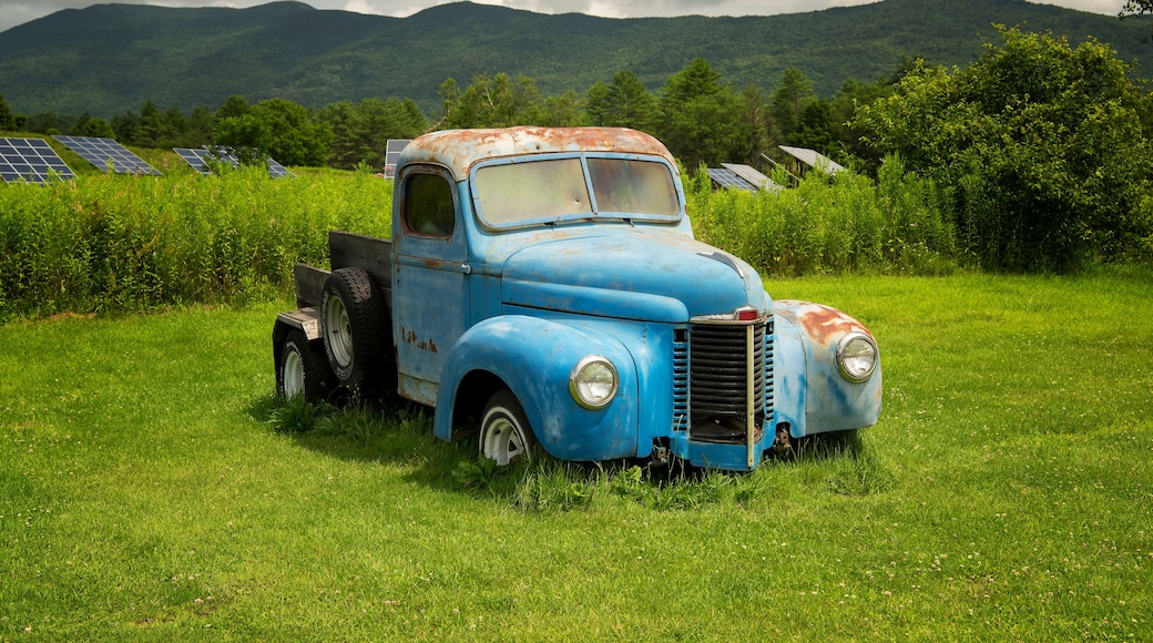 Antique and weathered blue pick up truck in vermont on a sunny day
