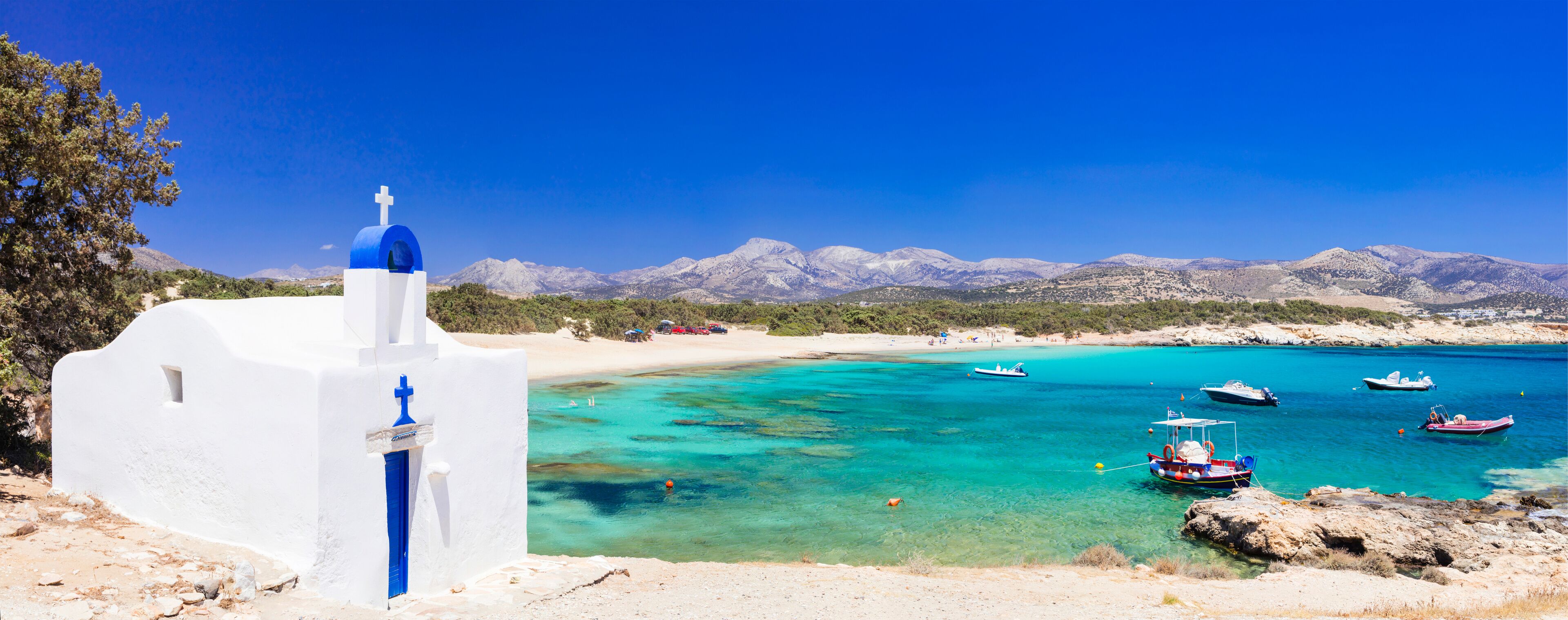 Traditional Greece - small church on the turquoise beach. Naxos island