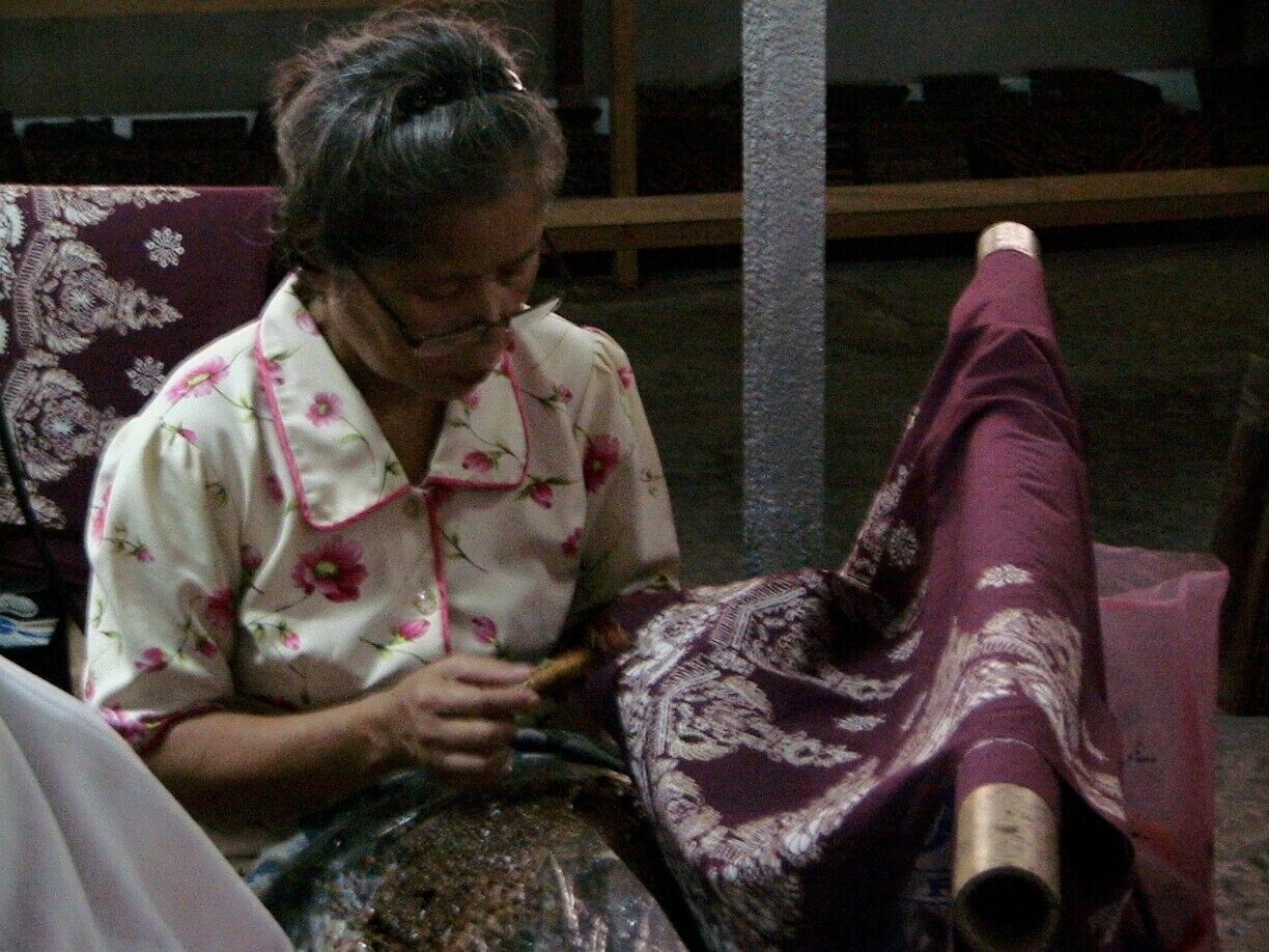 Traditional batik in Java was made with a copper stamp or drawn on cloth by hand using a tool called a chanting. A chanting is a little copper bowl with a spout attached to a wood or bamboo handle. The chanting is dipped into hot wax. The artist draws with the chanting by using the law of gravity. The wax to pours out of the spout and penetrates the fabric