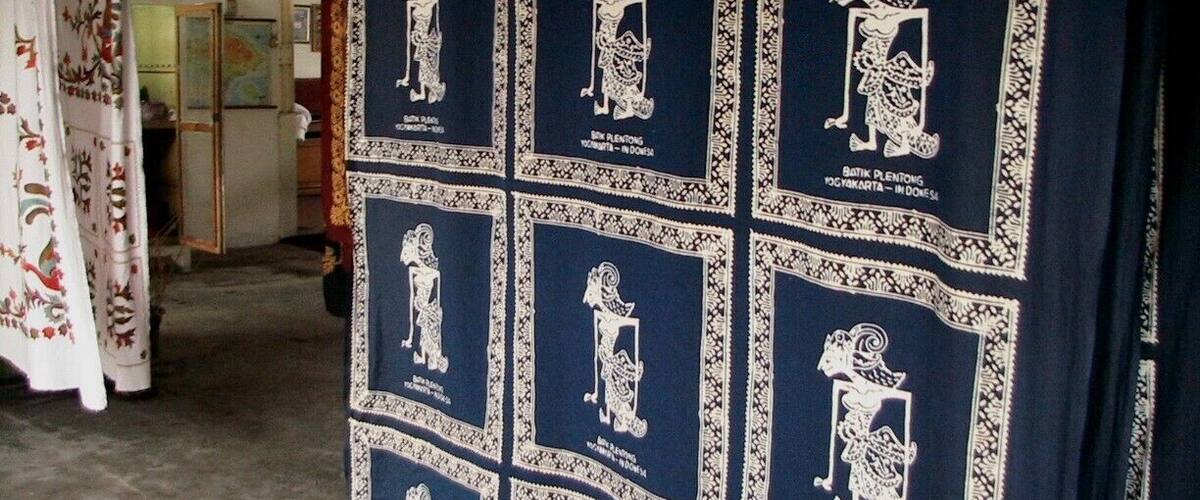 A wall decorated with framed illustrations of traditional figures.