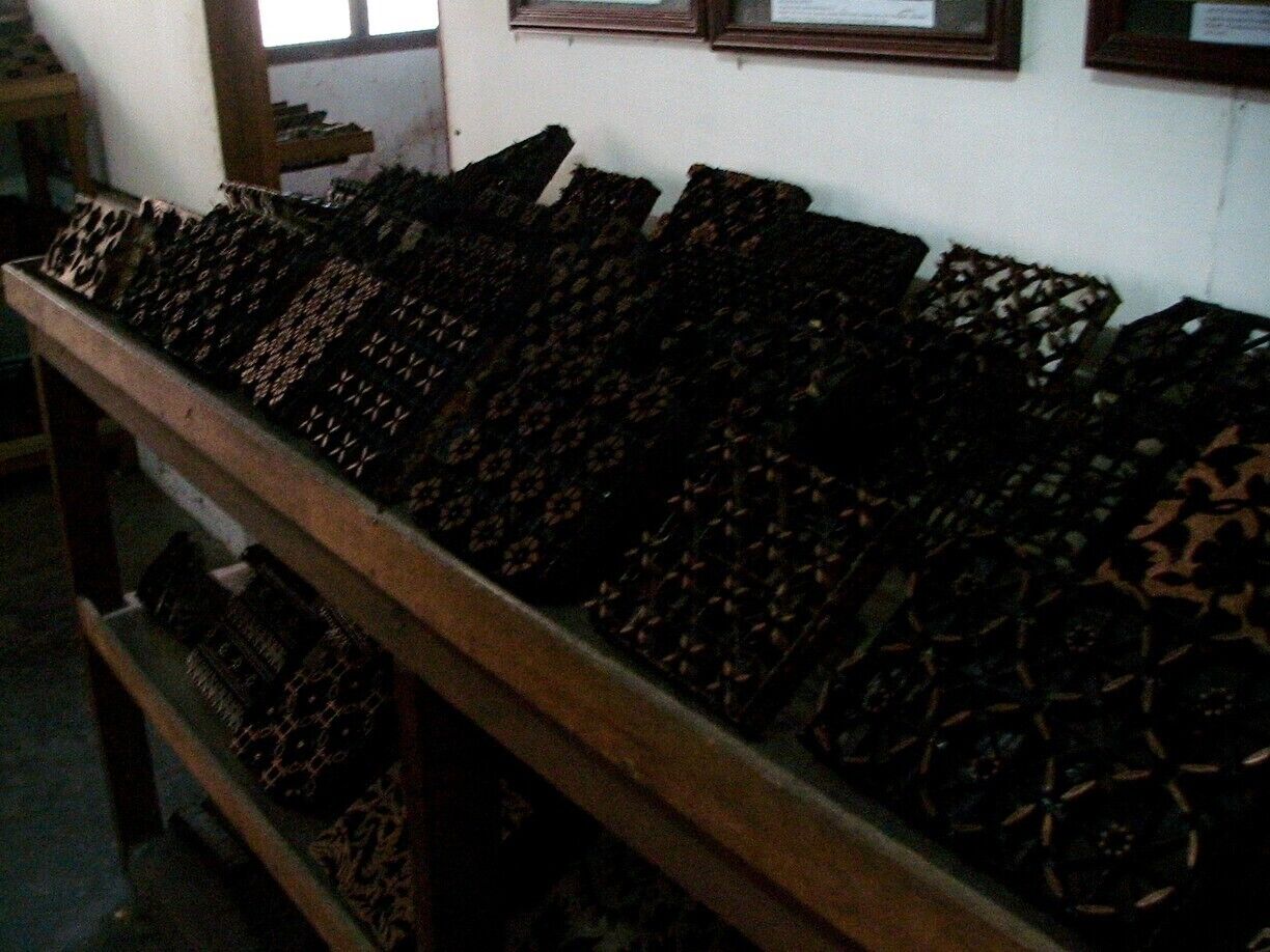 Copper stamps are used to apply hot wax onto the batik fabric. They are handmade of copper strips, carefully cut, shaped and soldered into fabulous shapes and patterns. They are used by Batik artists in Java by dipping them into hot wax, shaking off the excess, and then stamping the wax onto the cloth. Aligning the edges of each consecutive stamp creates patterns which run the length and width of the fabric. 