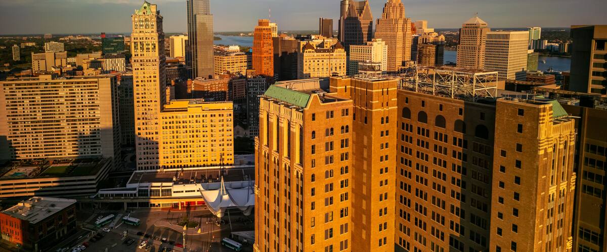 A cityscape with a variety of architectural styles, including modern skyscrapers and older, ornate buildings.