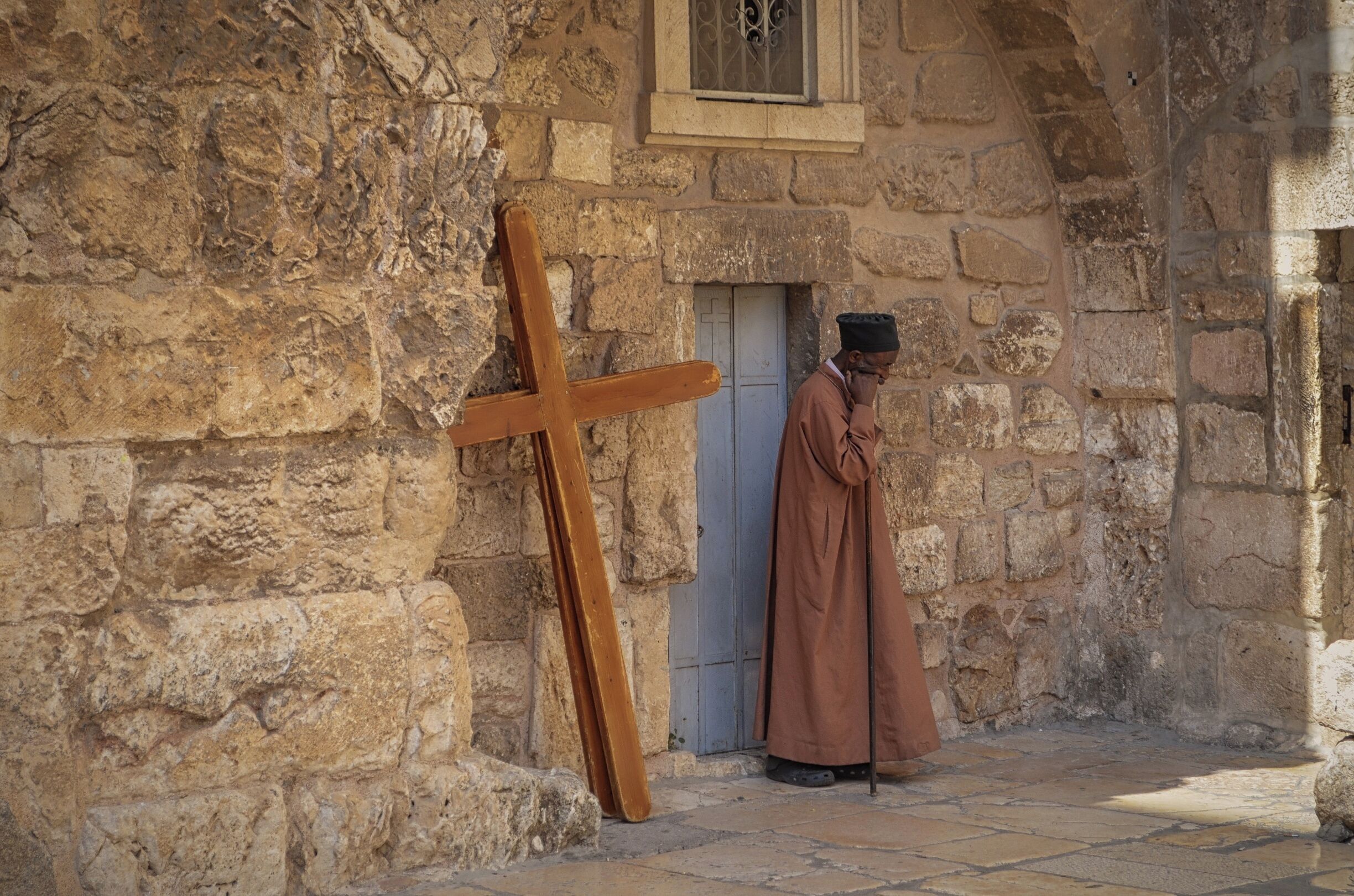 A monk, deep in thoughts at one of the side entrances of the holy sepulcher church in Jerusalem. If you have the chance to visit Jerusalem, don't miss the holy sepulcher. Even if you're not religious, it is quite impressive