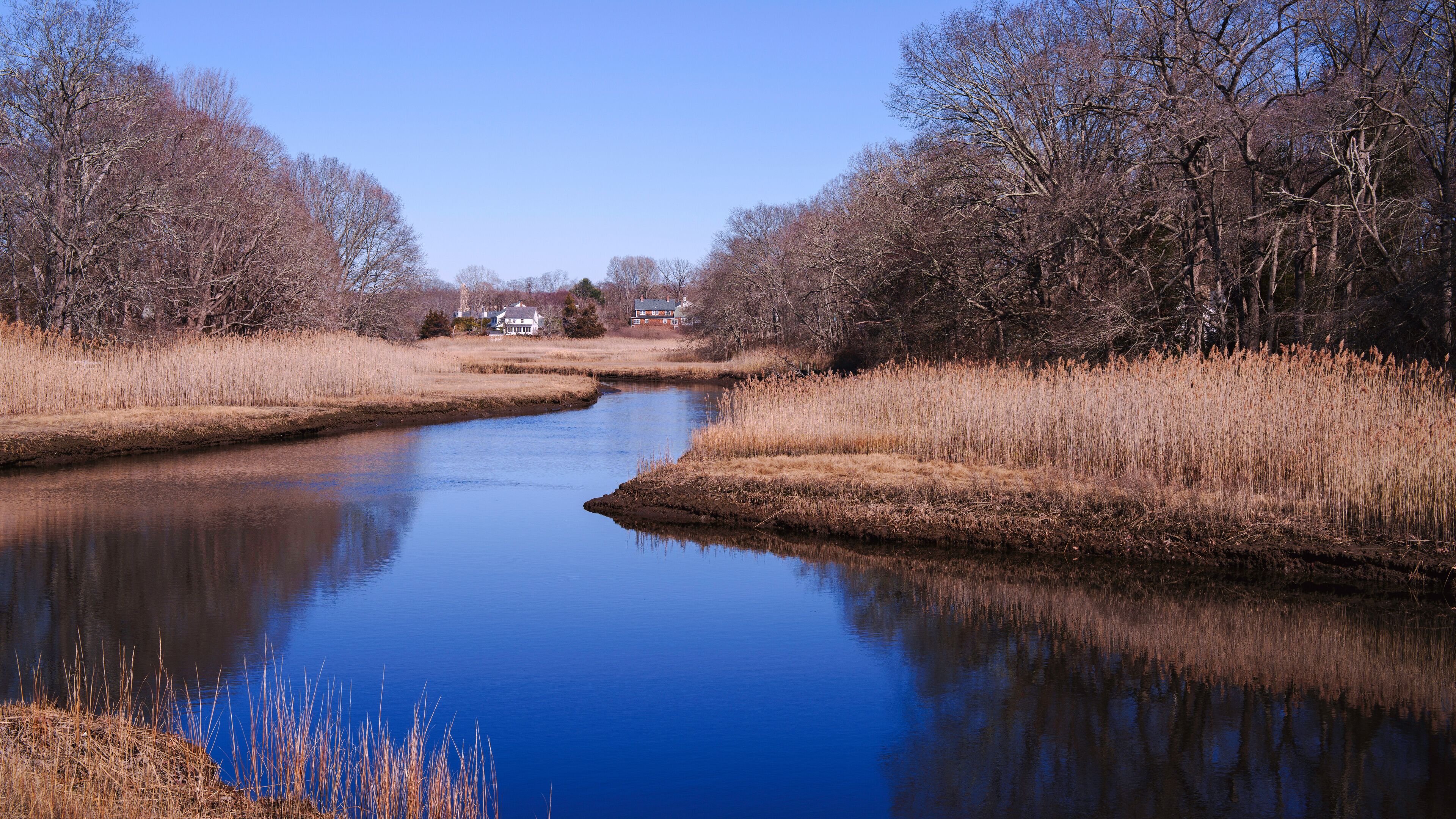 Westbrook Connecticut Landscape over the Patchogue River along the Salt Meadow National Wildlife Refuge in USA: A tranquil green space for fishing, hiking and walking in New England of America
