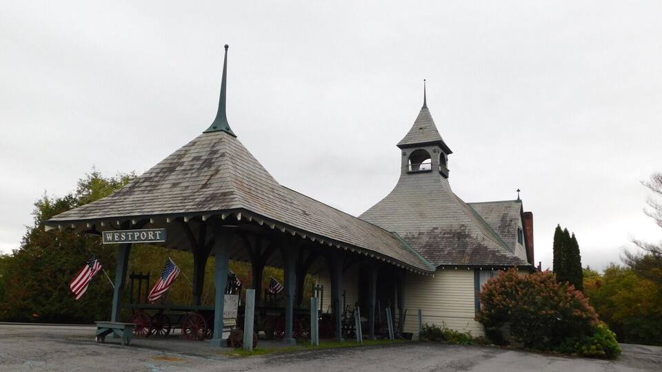 A historic building with a pointed roof and a bell tower, labeled "WESTPORT."