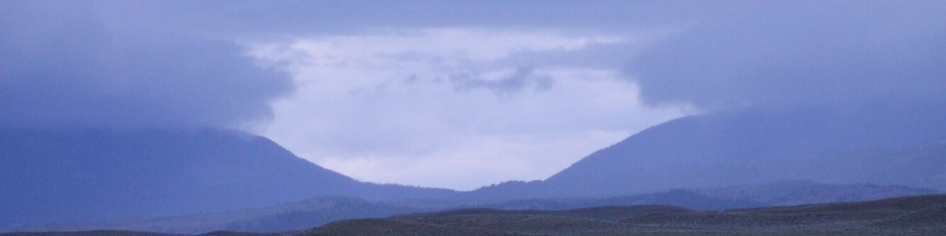 Don't remember the exact location this photo was taken. South of Lewis and Clark National Forest. Anyway, we just thought it was interesting, the gap in the clouds over the gap in the mountains