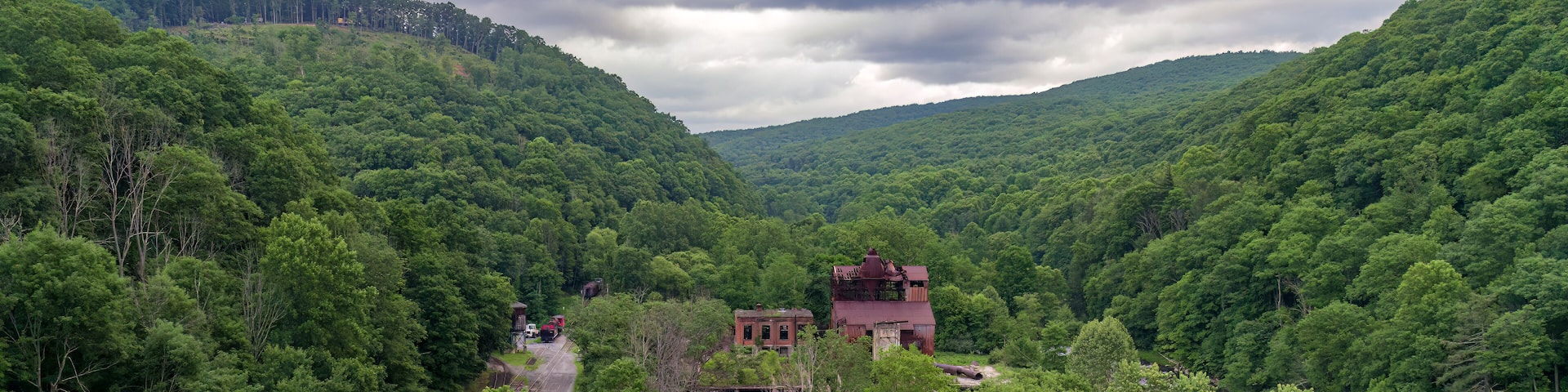 A Drone View of an Abandoned Lumber Mill, next to a River and Rail Road Tracks, in Cass West Virginia