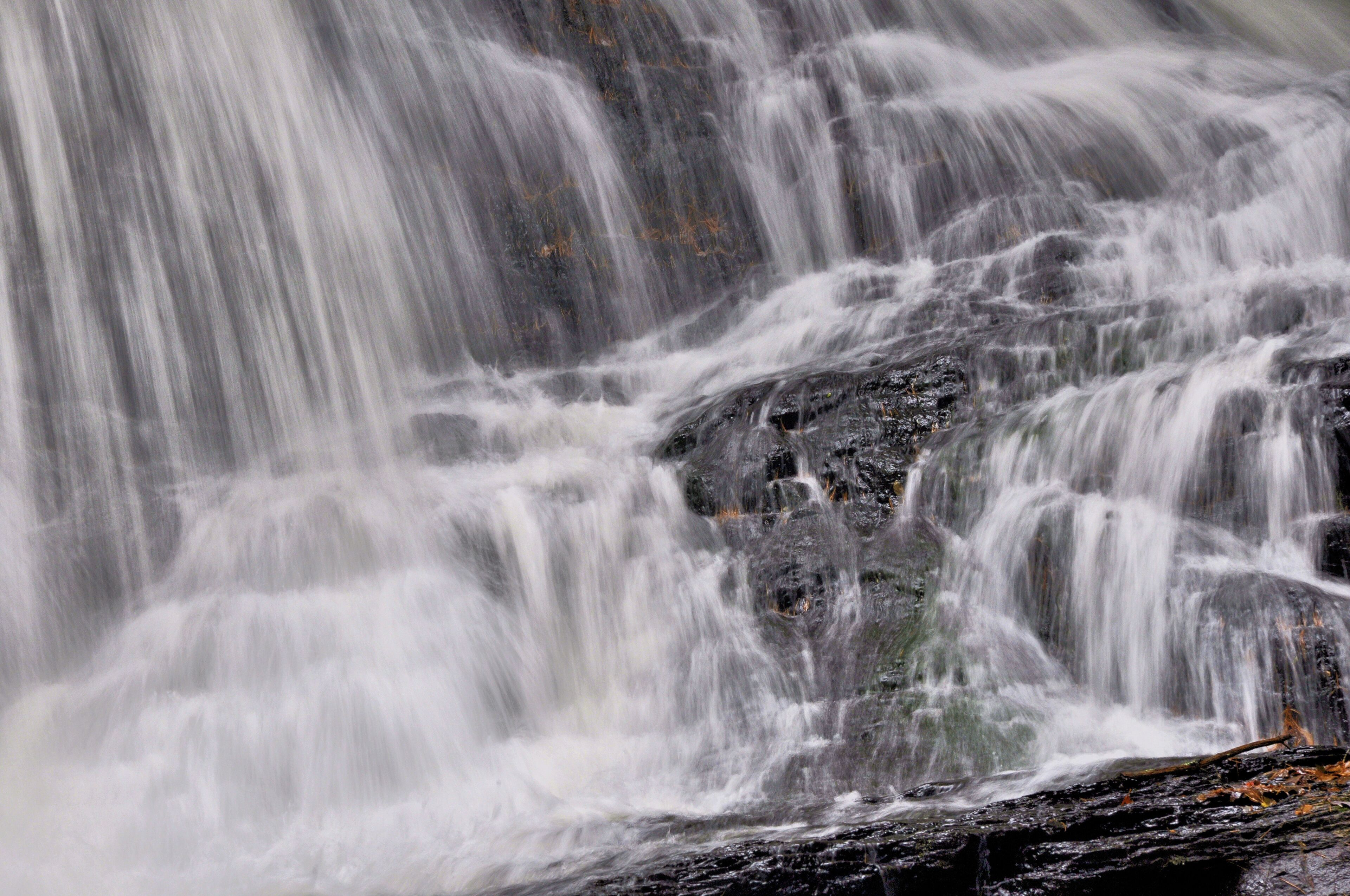 Closeup of white curtains of water plunging down scenic Garwin Falls in Wilton, New Hampshire.