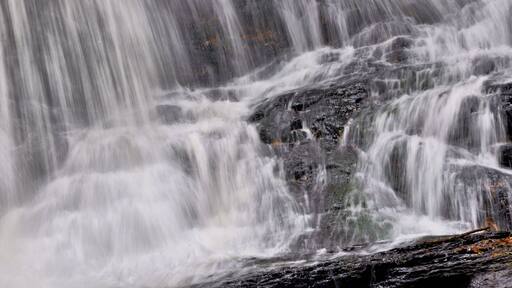 Closeup of white curtains of water plunging down scenic Garwin Falls in Wilton, New Hampshire.