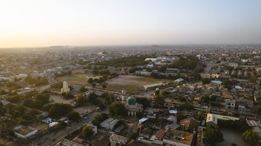 Aerial view of the Emir Palace Road area, with its buildings casting long shadows under the warm light, Kano, Kano, Nigeria.