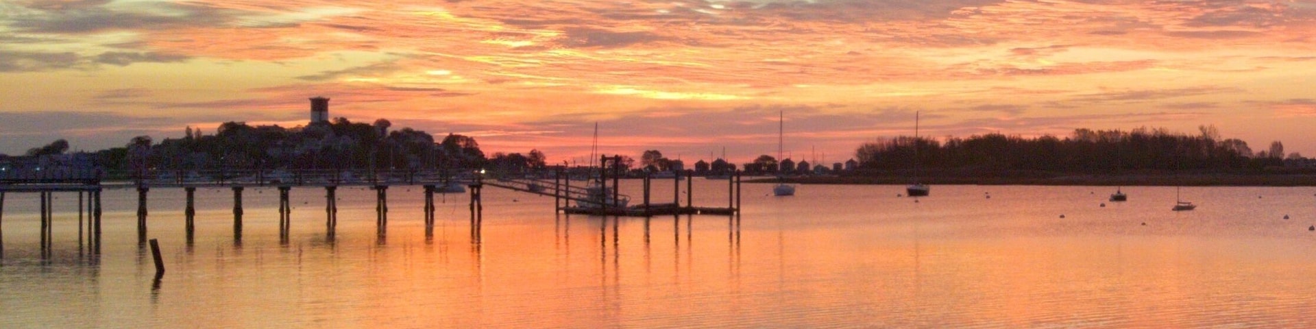 Shot at sunrise from the Cottage Park Yacht Club parking lot towards the Winthrop Water tower.
