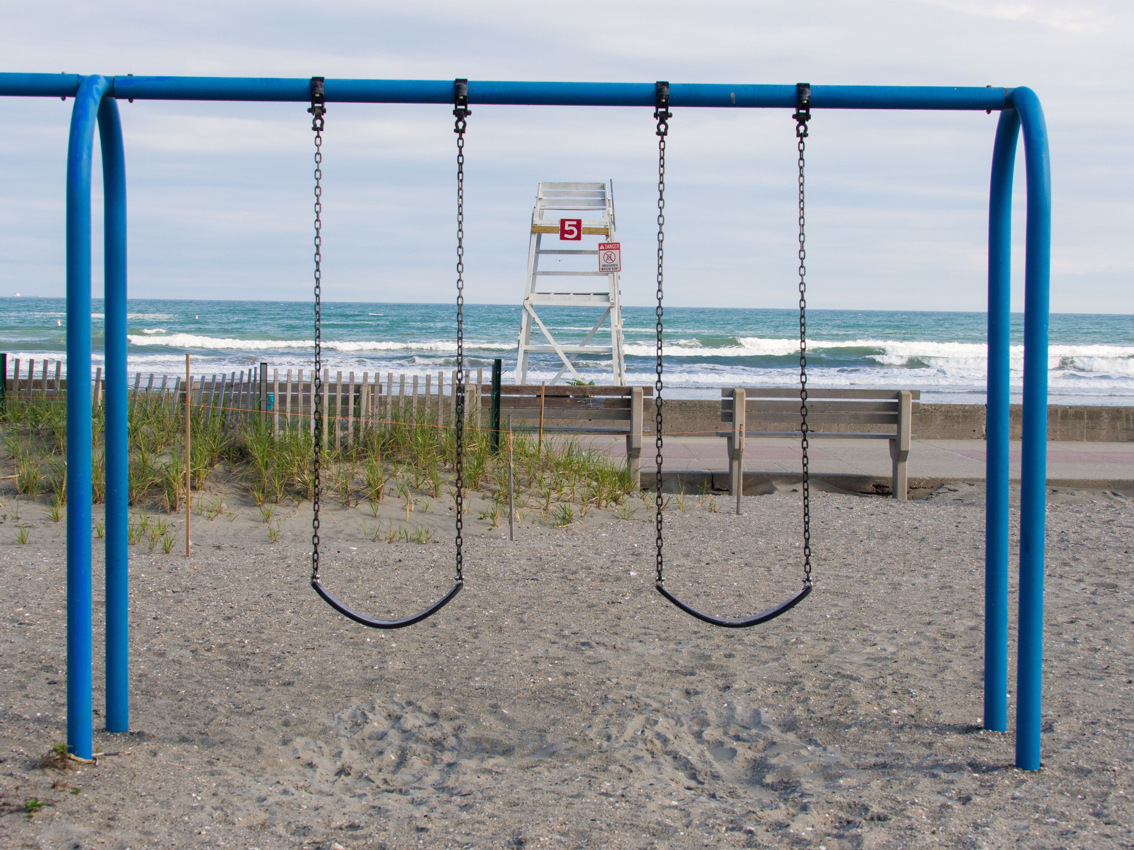 Two swings in front of a lifeguard tower at the beach, Newport, Rhode Island, USA