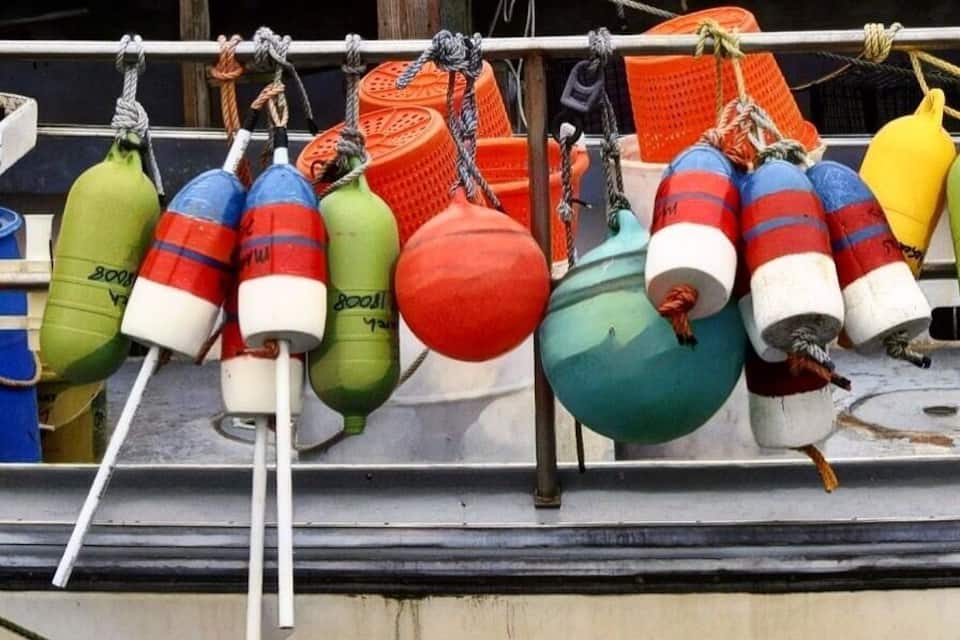 Colorful buoys and containers on a dock.
