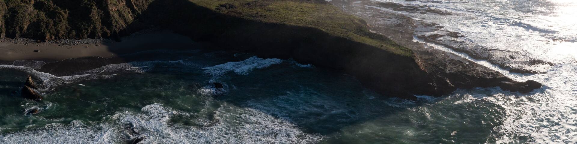 The cold Pacific Ocean washes onto the rugged coastline of Northern California north of Fort Bragg. The Pacific Coast Highway runs right along this scenic region in Mendocino County.