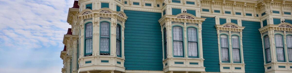 Closeup of traditional house in the city of Ferndale in Humboldt County, California, USA, famous for its Victorian architecture, a sunny day with blue sky and clouds in summer, space for text
