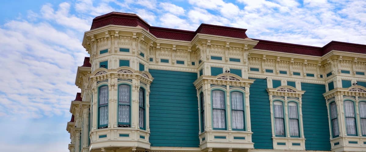 Closeup of traditional house in the city of Ferndale in Humboldt County, California, USA, famous for its Victorian architecture, a sunny day with blue sky and clouds in summer, space for text