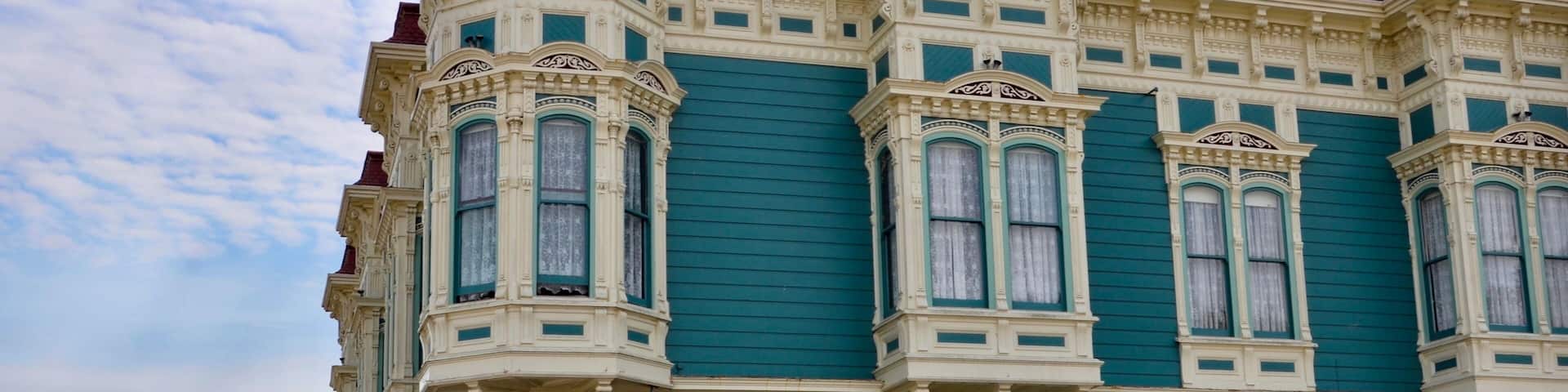 Closeup of traditional house in the city of Ferndale in Humboldt County, California, USA, famous for its Victorian architecture, a sunny day with blue sky and clouds in summer, space for text