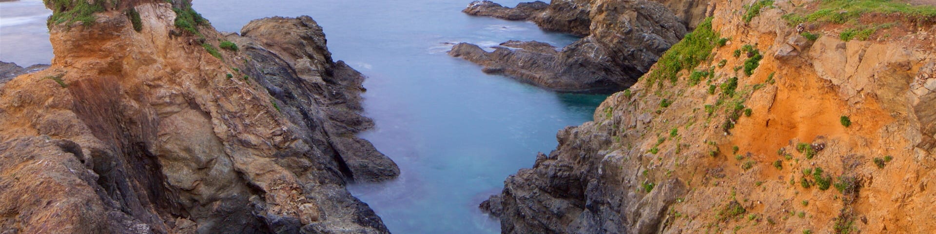 Mendocino which includes general coastal views, rocky coastline and a sunset