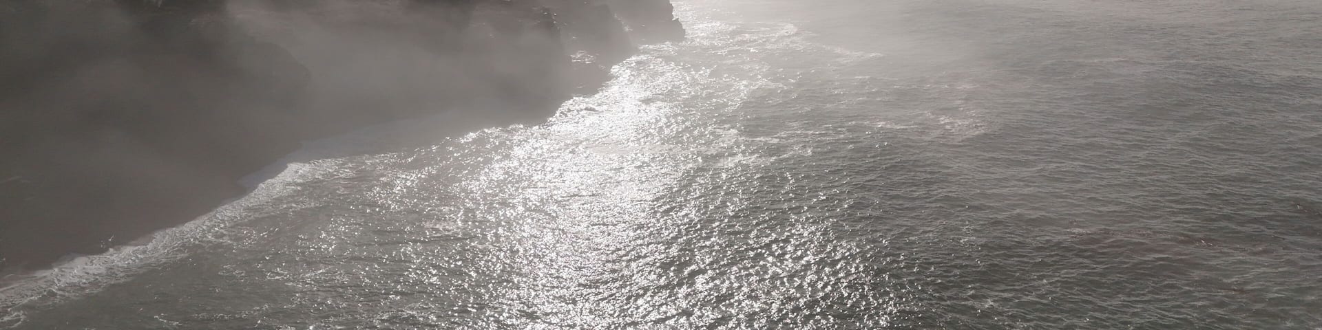 Aerial view of serene coastal fog over the ocean and coastline, Gualala, California, United States.