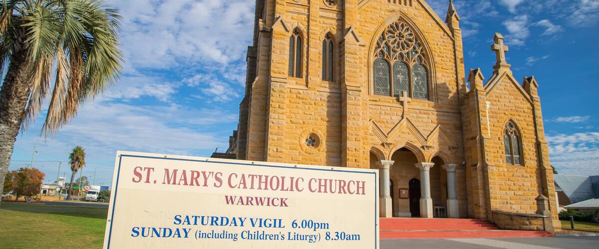 Warwick showing signage, a church or cathedral and heritage architecture