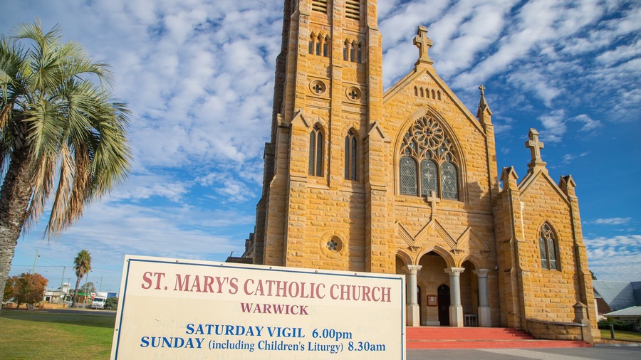 Warwick showing signage, a church or cathedral and heritage architecture