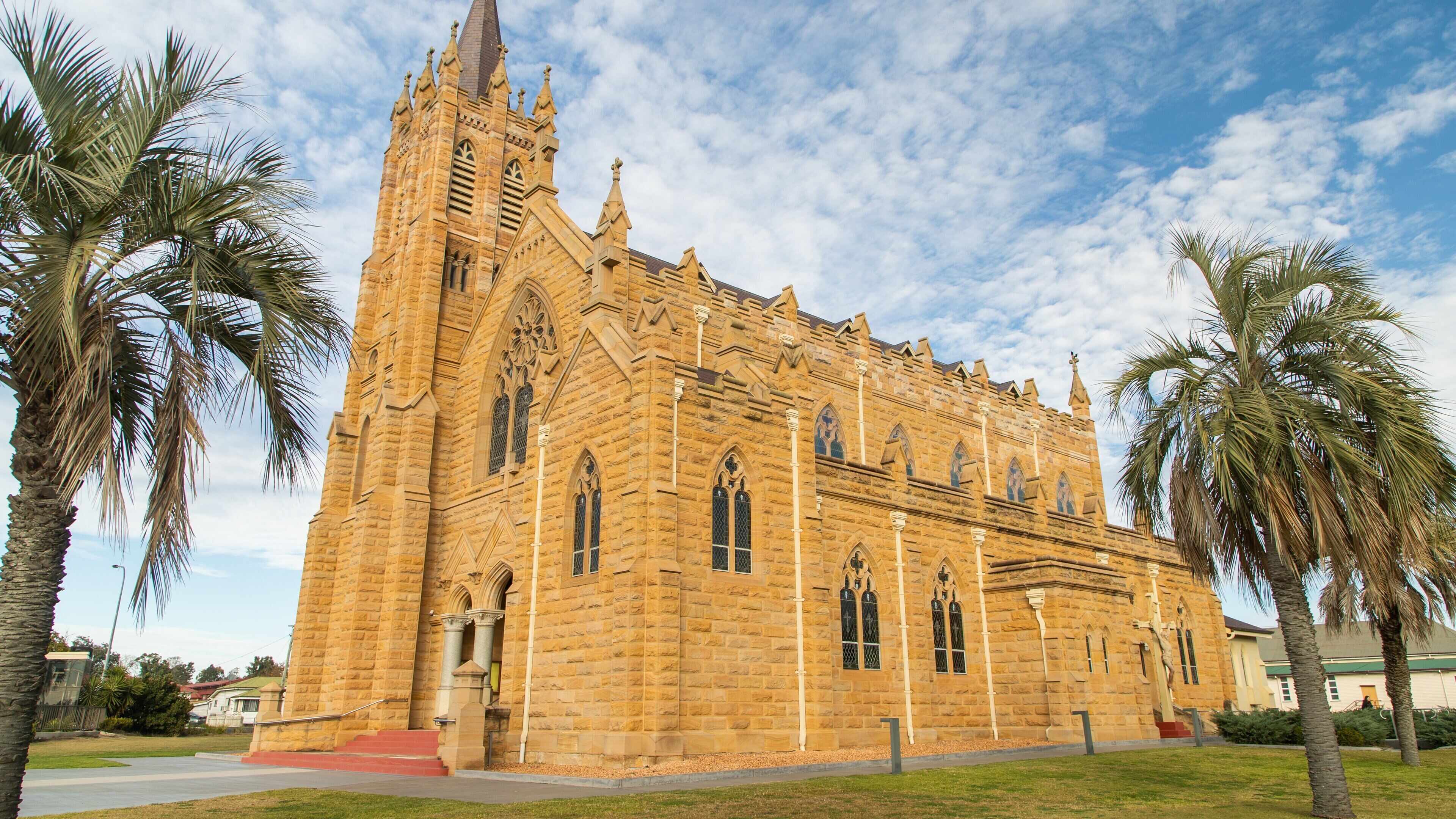 A large stone church with pointed arches and a tall spire.