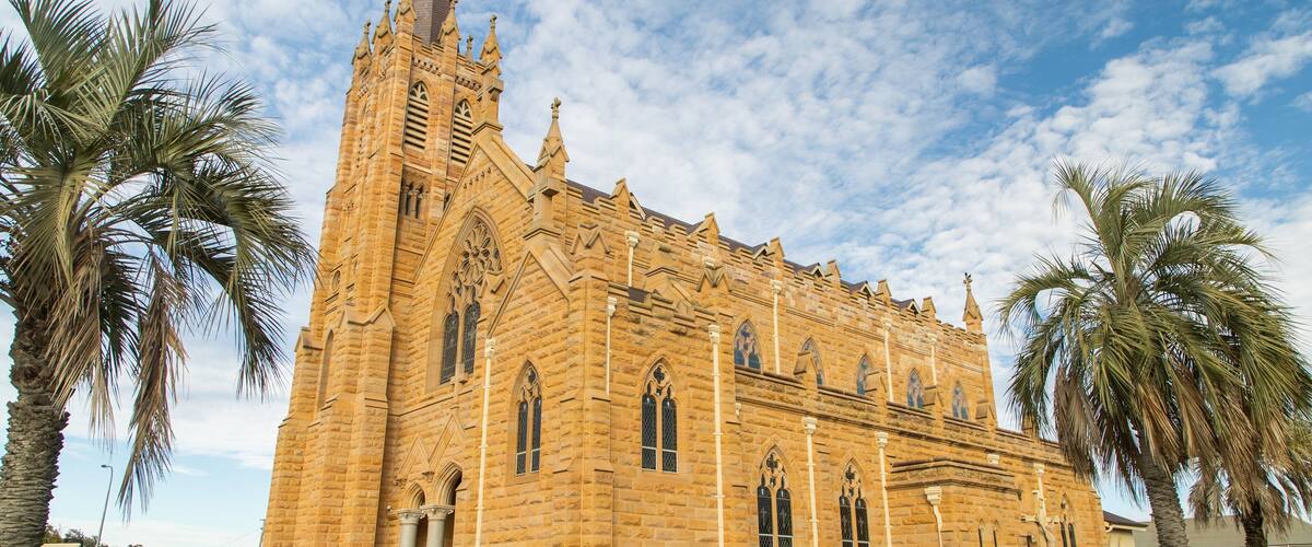 A large stone church with pointed arches and a tall spire.