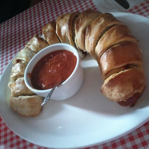 Stromboli with pepperoni, sausage, provolone and green olives.