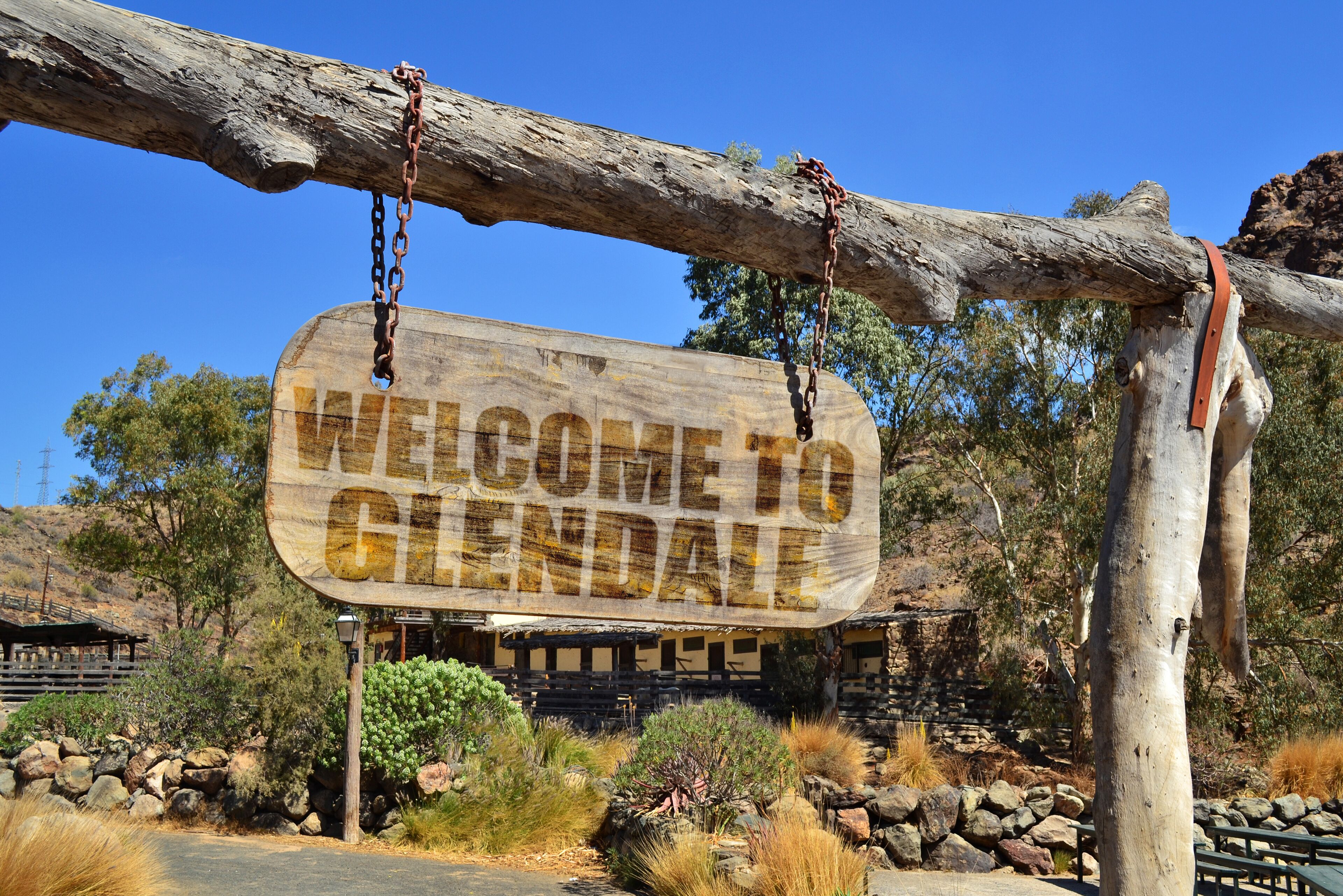 wood signboard with text " welcome to Glendale" hanging on a branch