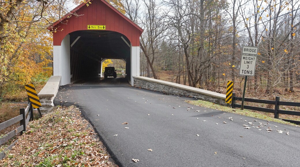 Red and White Wooden Covered Bridge in Daylight