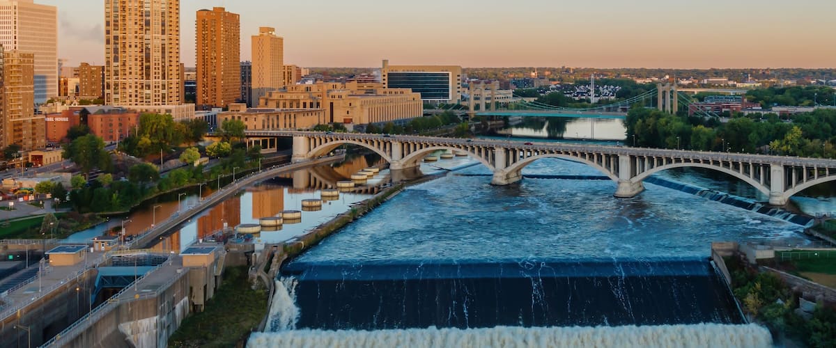 Minneapolis skyline at dawn, St. Anthony Falls dam, powerful water flow. City views, bridges, and the Mississippi River. Upper Pool, Minneapolis, Minnesota, United States