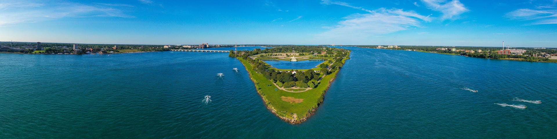 Looking towards the East, this aerial panoramic view shows the Western tip of Belle Isle below while showing Windsor, Ontario on the right and Detroit, Michigan on the left.