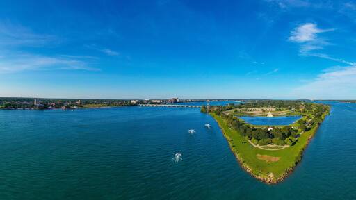 Looking towards the East, this aerial panoramic view shows the Western tip of Belle Isle below while showing Windsor, Ontario on the right and Detroit, Michigan on the left.