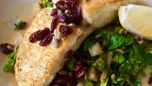 Braised Halibut rests atop of a bed of colorful vegetable crunch blend surrounded with a roasted garlic broth. Finished with cranberries and sunflowers seeds. #GoodEats #eatlocal