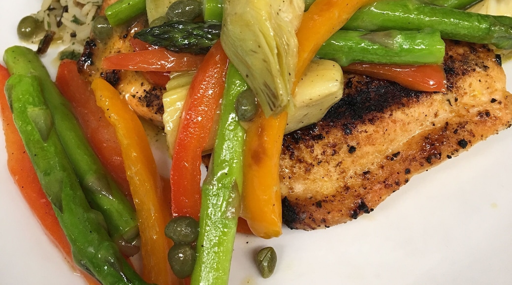 Mediterranean Grilled Salmon topped with asparagus, peppers capers and artichoke served over wild rice. #GoodEats