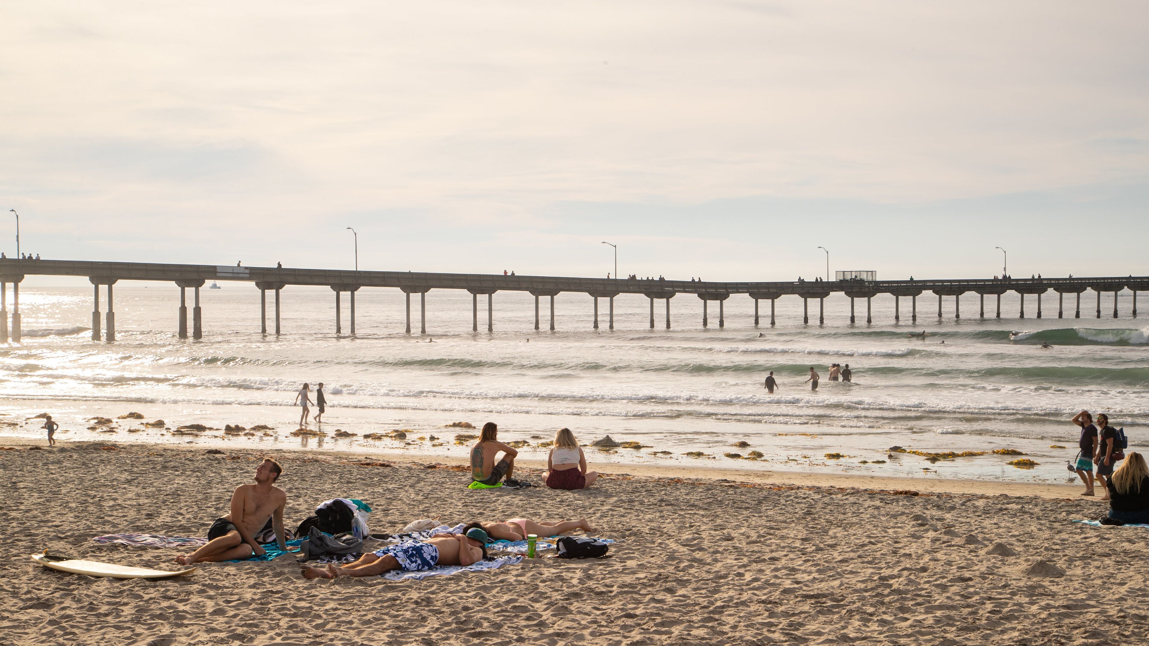 Ocean Beach which includes a sandy beach, a sunset and general coastal views