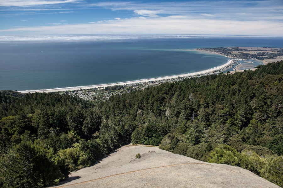 Seen from hiking trails in the hills, the gentle curve of Stinson Beach, just north  of San Francisco, California, stretches northward on a sunny day