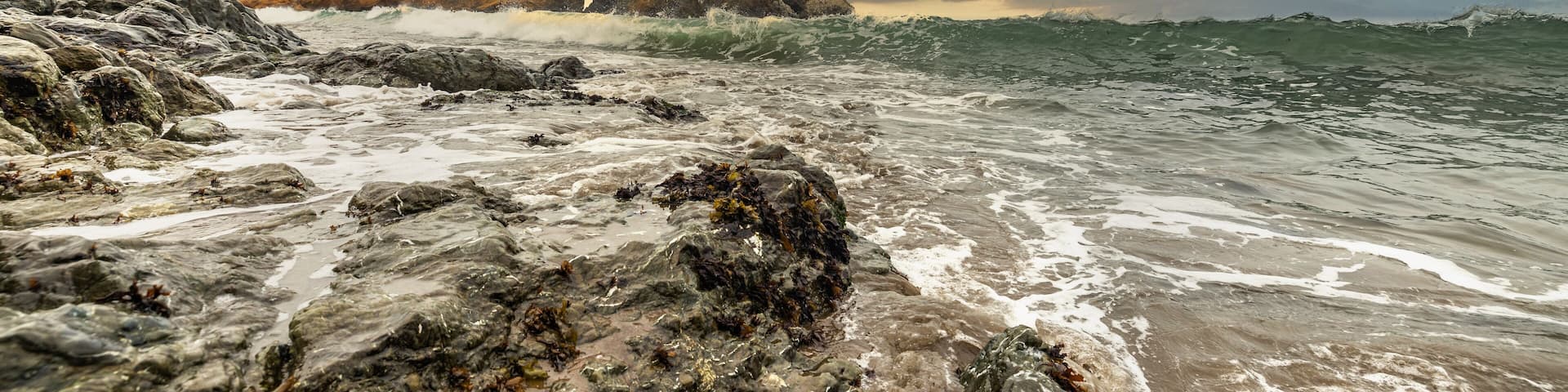 Rock formations against the backdrop of the ocean in the San Francisco Recreation Area, Rodeo Beach, California, USA. Seaside, beautiful landscape, California coast.