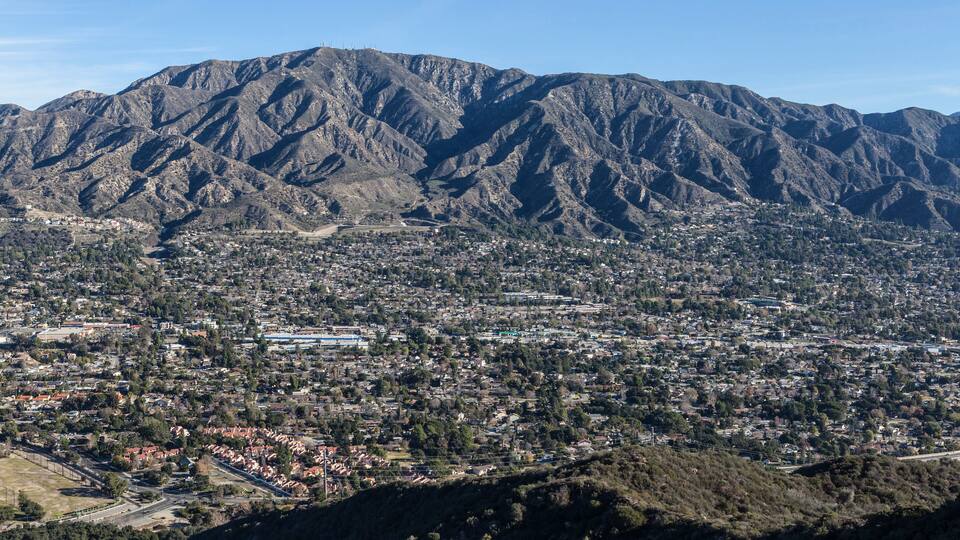 A mountainous landscape with a town nestled in the valley.